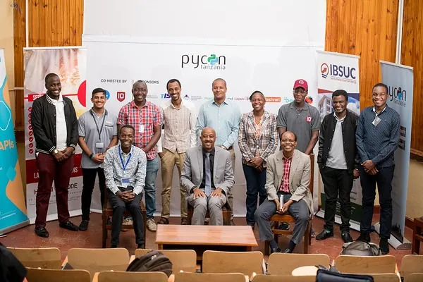 The PyCon Tanzania community gathered in front of the conference backdrop